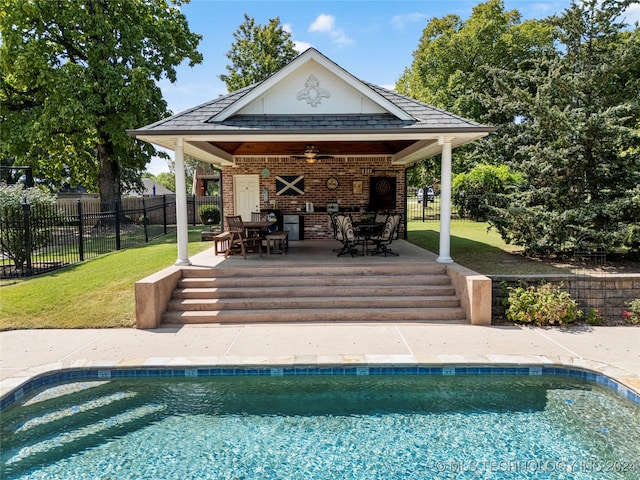 view of pool featuring a yard, a patio, ceiling fan, and a gazebo