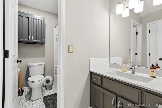 bathroom featuring vanity, toilet, and tile patterned flooring