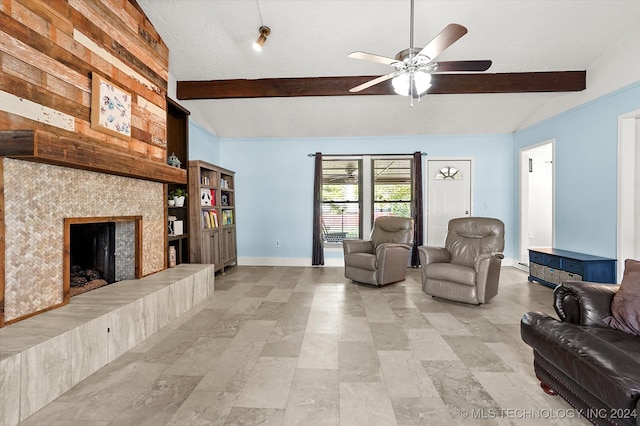 living room with a fireplace, lofted ceiling with beams, and ceiling fan