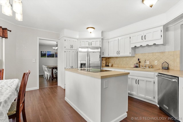 kitchen with white cabinets, stainless steel appliances, a notable chandelier, dark wood-type flooring, and a kitchen island