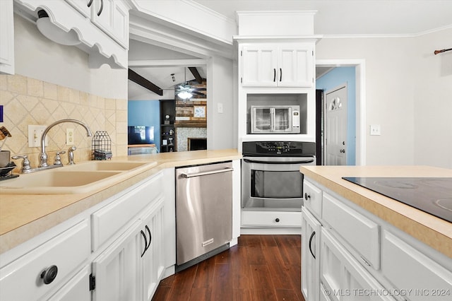 kitchen featuring sink, ceiling fan, dark hardwood / wood-style floors, appliances with stainless steel finishes, and white cabinets