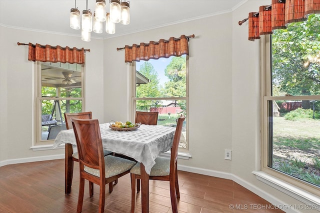 dining space with ornamental molding, a chandelier, and hardwood / wood-style floors