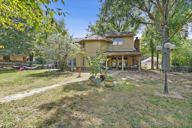 view of front of house with a patio area and a front lawn