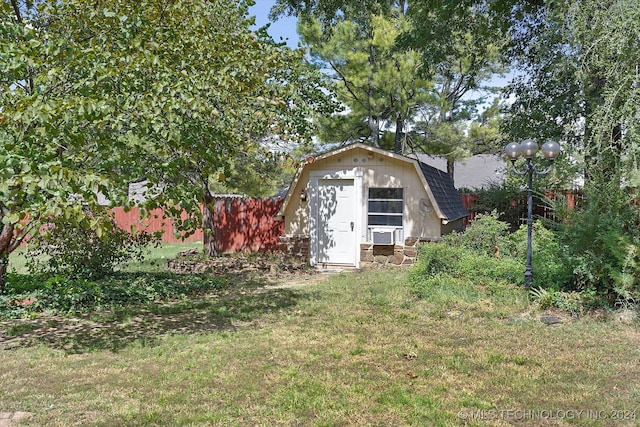 view of outbuilding featuring a lawn and cooling unit