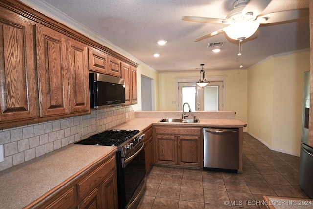 kitchen featuring appliances with stainless steel finishes, backsplash, sink, and kitchen peninsula