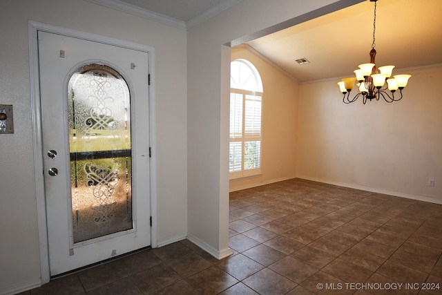 entrance foyer with lofted ceiling, an inviting chandelier, crown molding, and dark tile patterned flooring