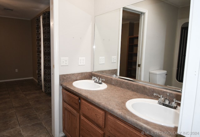 bathroom featuring crown molding, vanity, toilet, and tile patterned floors