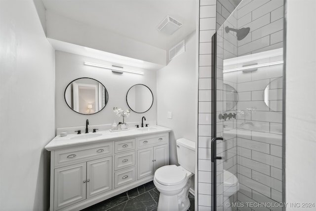 bathroom featuring vanity, toilet, and a shower with door