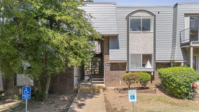 multi unit property with stairway and brick siding