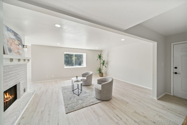 living room featuring a fireplace and light hardwood / wood-style flooring