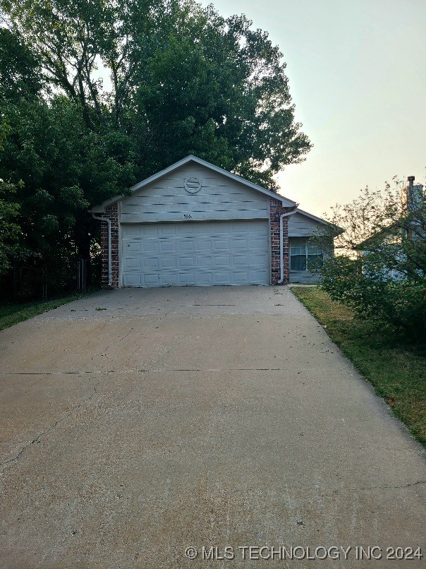 view of garage at dusk