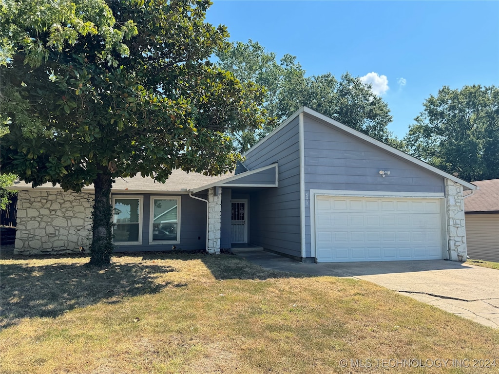 view of front of property with a garage and a front lawn