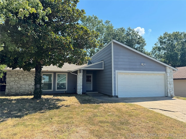 view of front of property with a garage and a front lawn