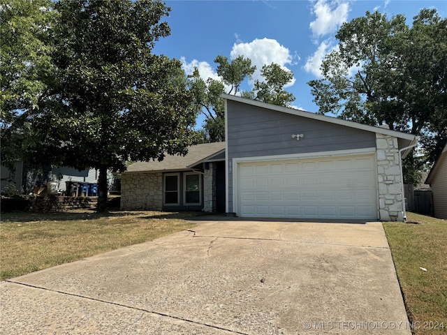 view of front of property with a garage and a front yard