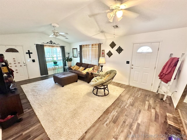 living room featuring ceiling fan, hardwood / wood-style floors, and vaulted ceiling