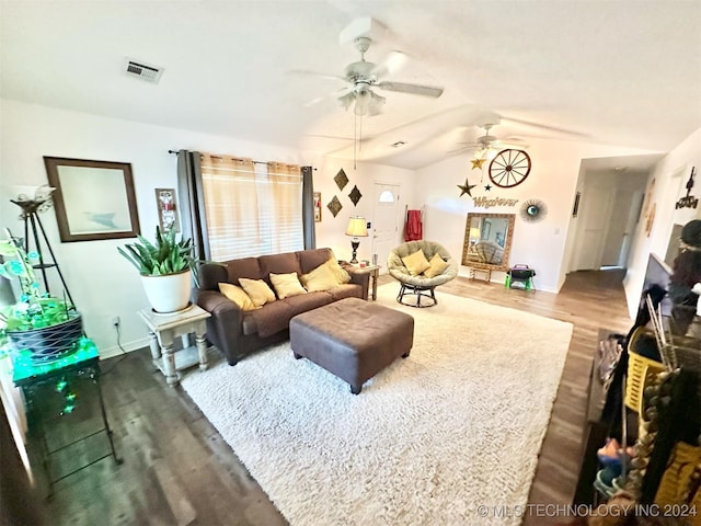 living room with ceiling fan, hardwood / wood-style flooring, and vaulted ceiling