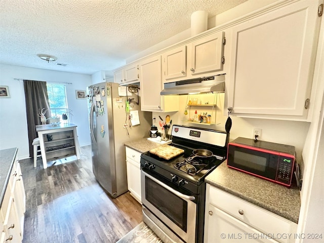 kitchen featuring appliances with stainless steel finishes, hardwood / wood-style flooring, and white cabinetry