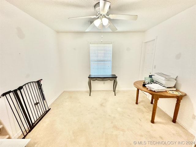 miscellaneous room featuring light carpet, a textured ceiling, and ceiling fan