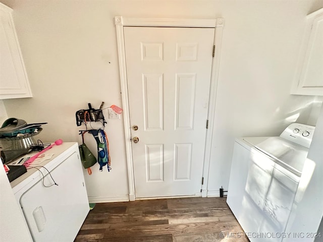 laundry area featuring cabinets, independent washer and dryer, and dark hardwood / wood-style flooring