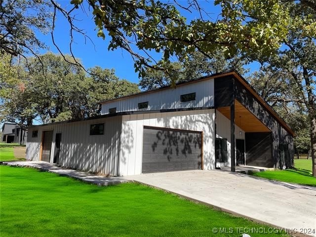 exterior space with a garage and a front lawn