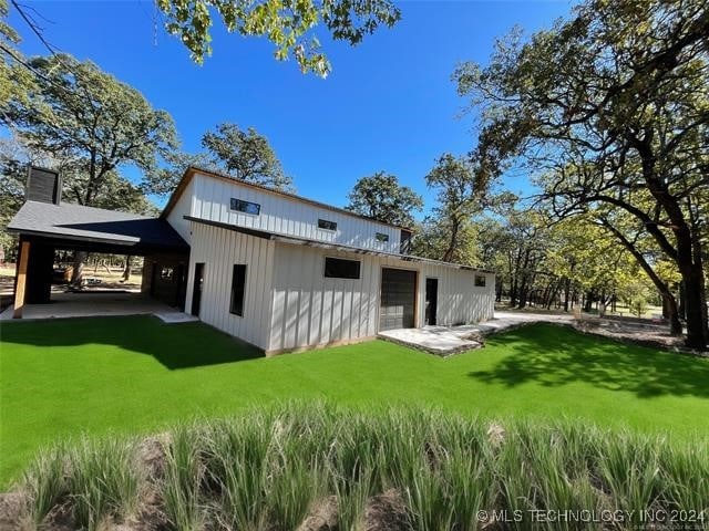 back of house with a lawn