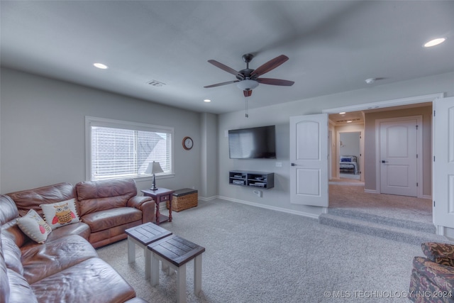 living room with ceiling fan and light carpet