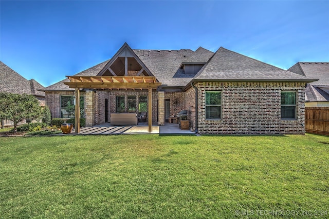 back of property with a pergola, a patio area, and a lawn