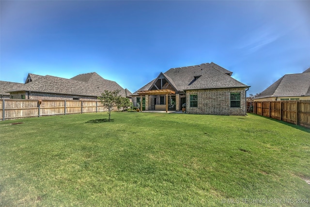 back of house featuring a yard and a patio