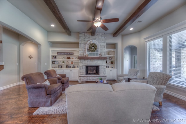 living room with beamed ceiling, ceiling fan, dark hardwood / wood-style flooring, and a fireplace