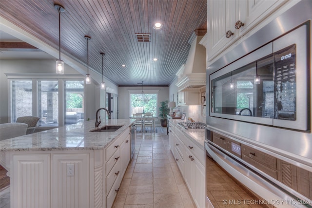 kitchen with pendant lighting, a spacious island, wood ceiling, and backsplash