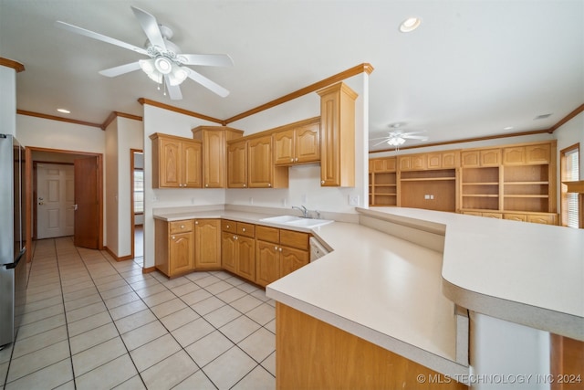 kitchen with kitchen peninsula, ceiling fan, crown molding, and sink