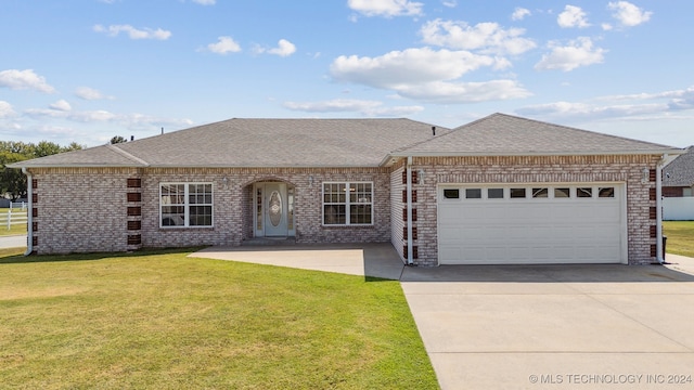 single story home featuring a garage and a front lawn