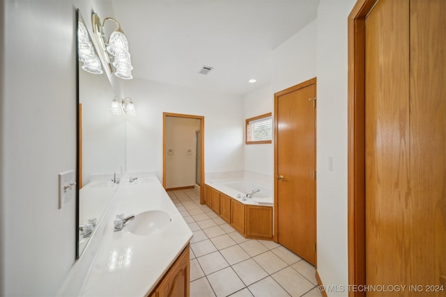 bathroom with vanity, tile patterned floors, and a tub