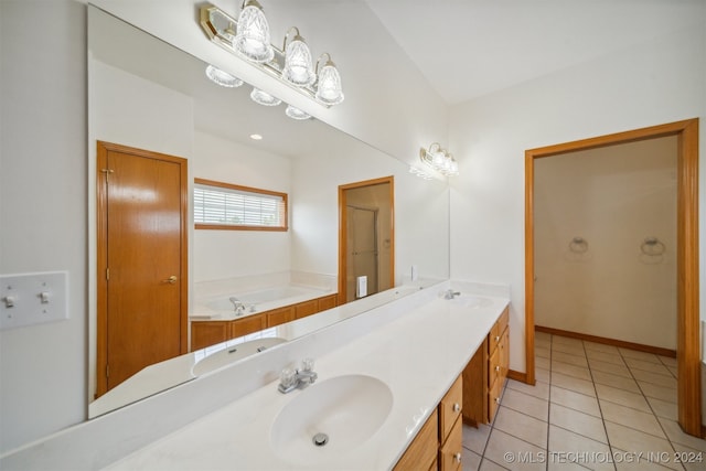 bathroom with vanity, a bathtub, and tile patterned flooring