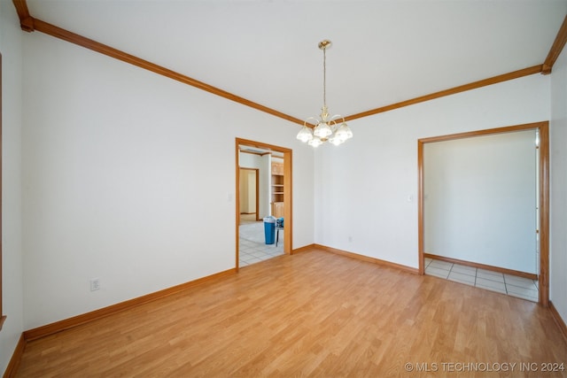 empty room featuring an inviting chandelier, crown molding, and hardwood / wood-style floors