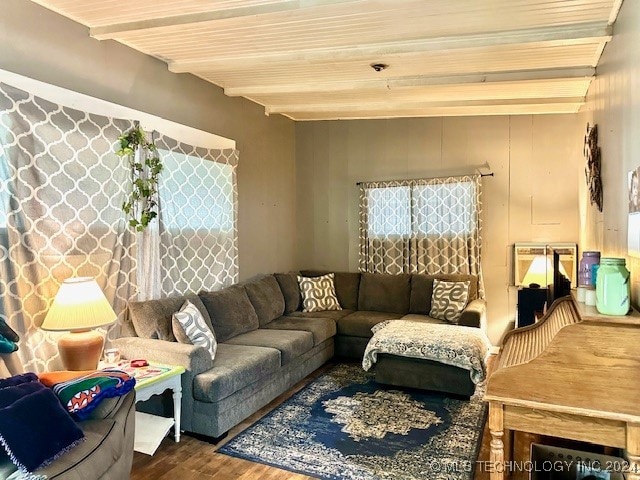 living room featuring hardwood / wood-style floors and beamed ceiling