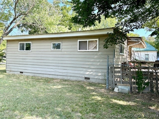 view of side of property with a yard