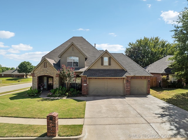 view of front facade featuring a front yard and a garage