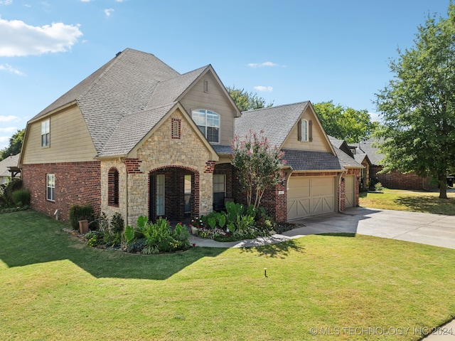 view of front of property featuring a garage and a front lawn