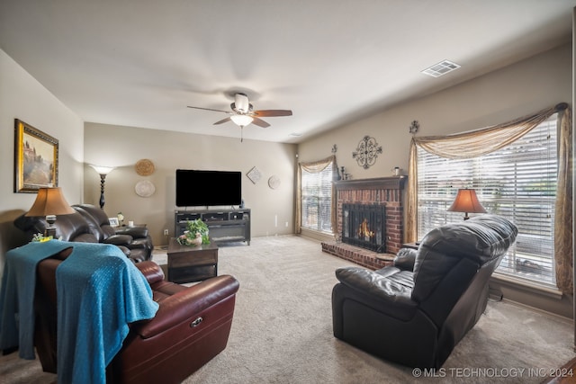 living room with carpet, ceiling fan, plenty of natural light, and a fireplace