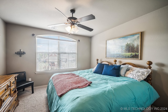 bedroom with ceiling fan and light colored carpet