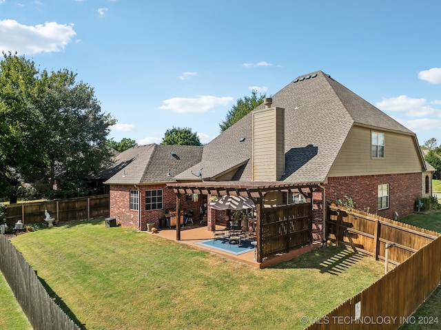 rear view of property featuring a lawn and a patio