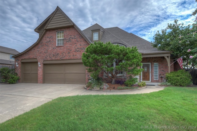 view of property featuring a front lawn and a garage