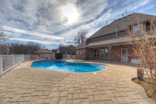 view of pool with a patio area, a fenced in pool, and fence