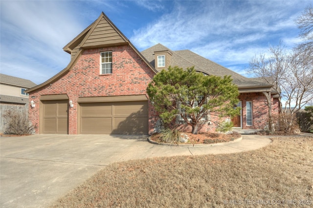 view of front of house featuring brick siding, an attached garage, driveway, and a shingled roof