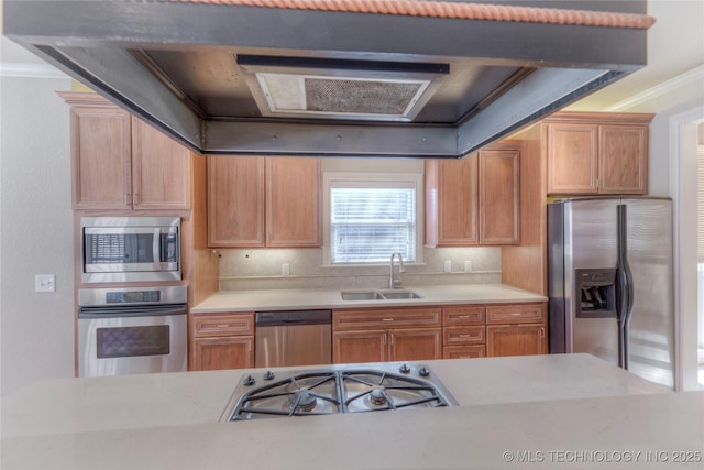 kitchen featuring a sink, stainless steel appliances, crown molding, and light countertops