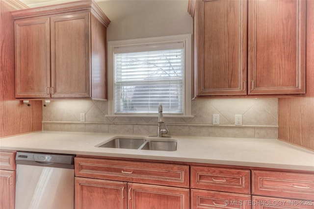 kitchen featuring a sink, tasteful backsplash, stainless steel dishwasher, and light countertops