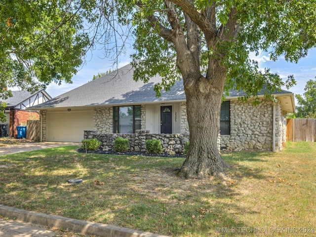 single story home with a front lawn and a garage