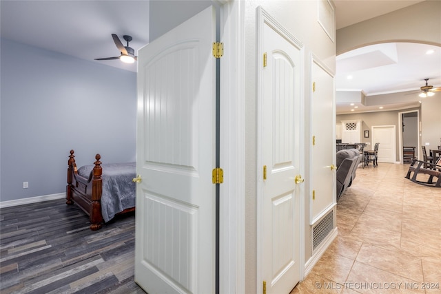 hallway featuring arched walkways, recessed lighting, and ornamental molding
