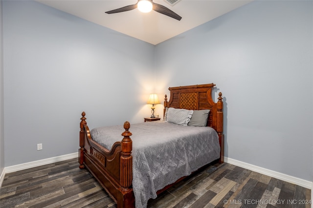 bedroom with dark hardwood / wood-style flooring and ceiling fan